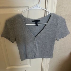 A grey cropped button up